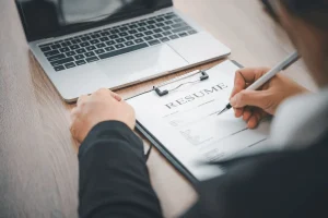 job seeker writing his change in career resume