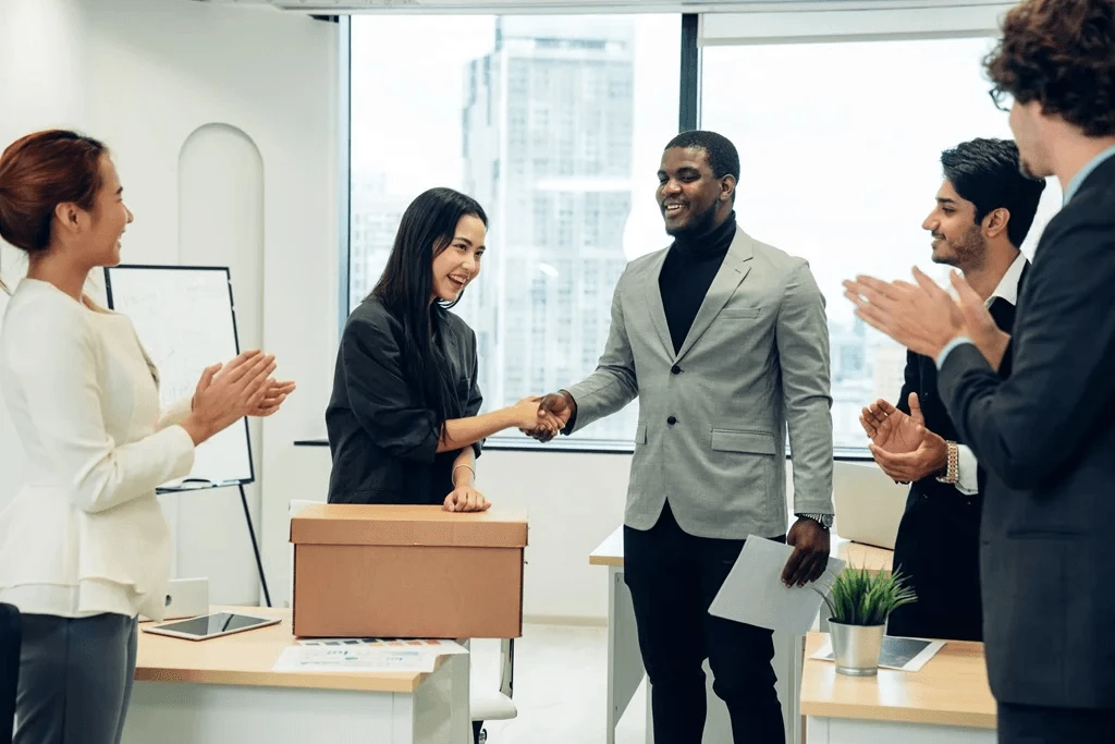 Newly Hired Job Candidate Shaking Hands With Her Manager