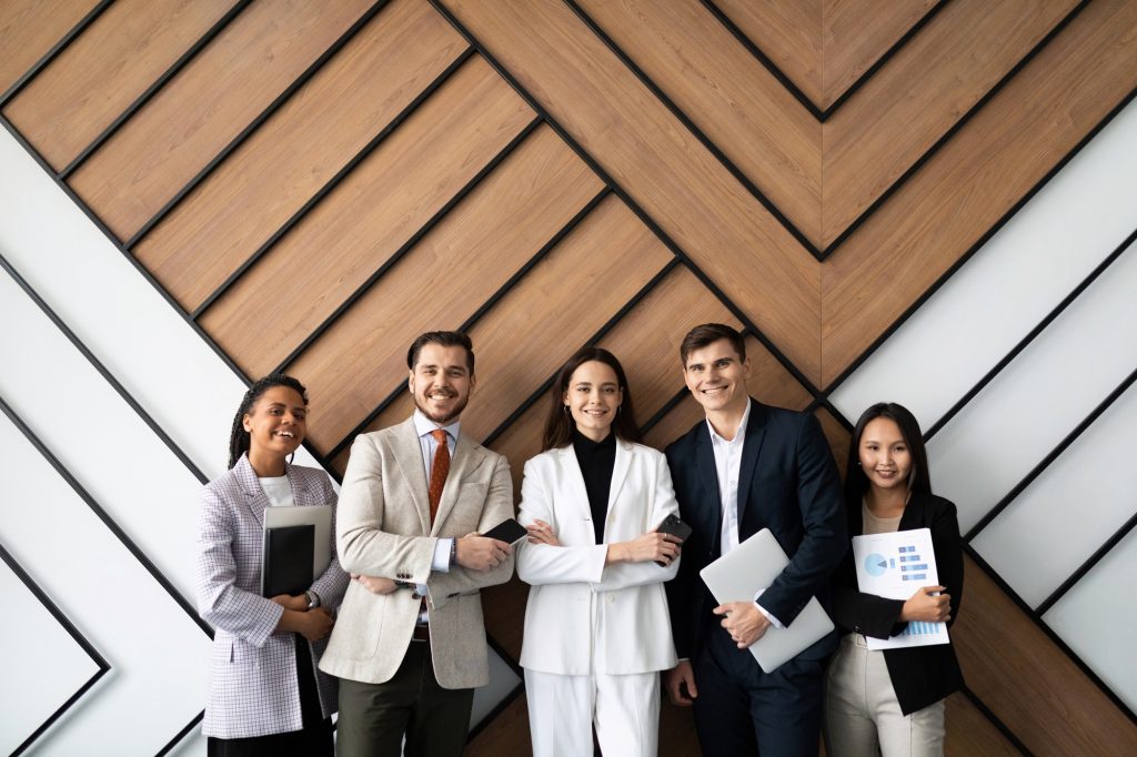 Smiling Young And Old Multiracial Workers Staff Group Pose Together As Human Resource