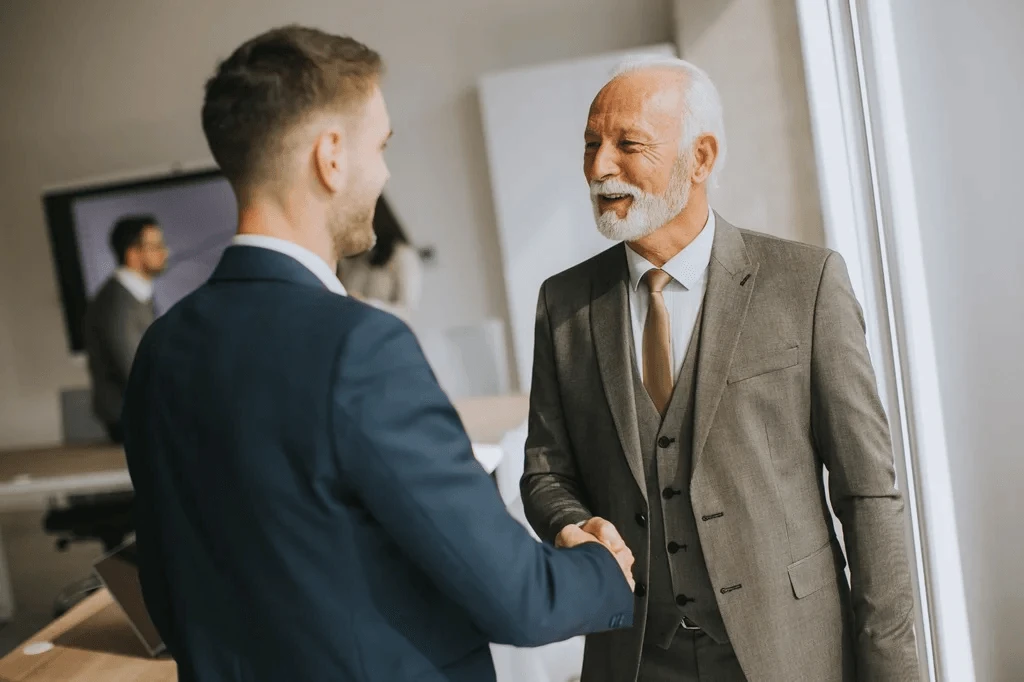 Young Professional Shaking Hands With A Professor