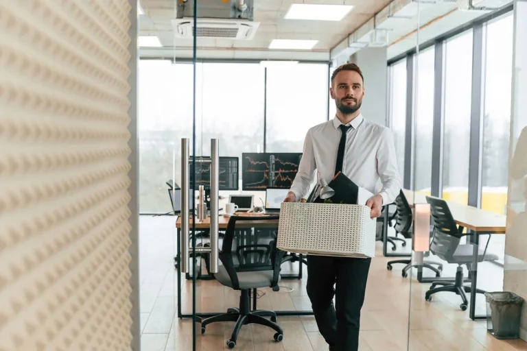 career changer carrying his office stuff