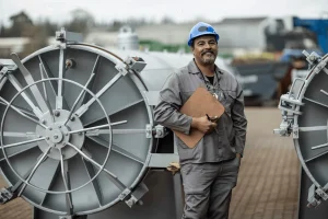 director of maintenance beside large machines