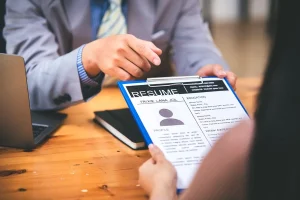 Job Applicant Submitting Her Resume During An Interview