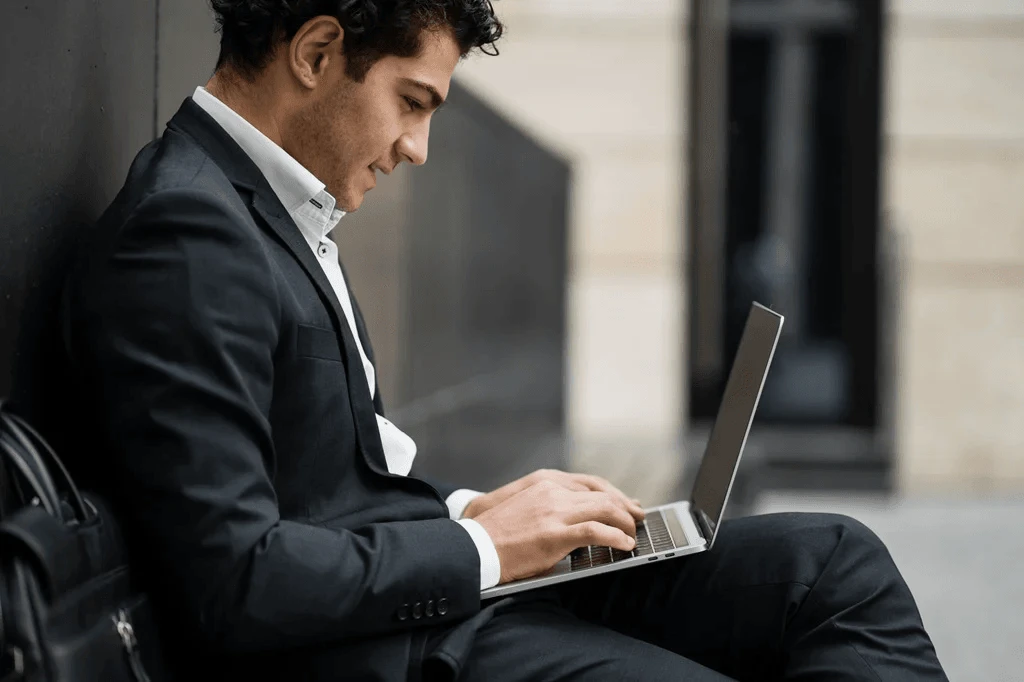 Job Seeker Using His Laptop To Research Different Resume Formats