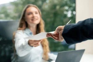 professional handing over a letter of introduction for networking purposes