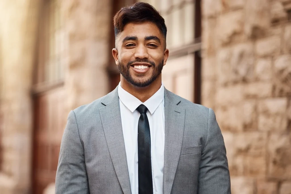 Professional Headshot Of An Employee With An Old Structure As A Backdrop