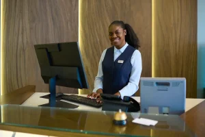 Smiling Receptionist At The Office Desk