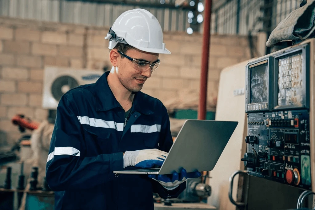 Worker Checking His Director Of Maintenance Resume Using A Laptop