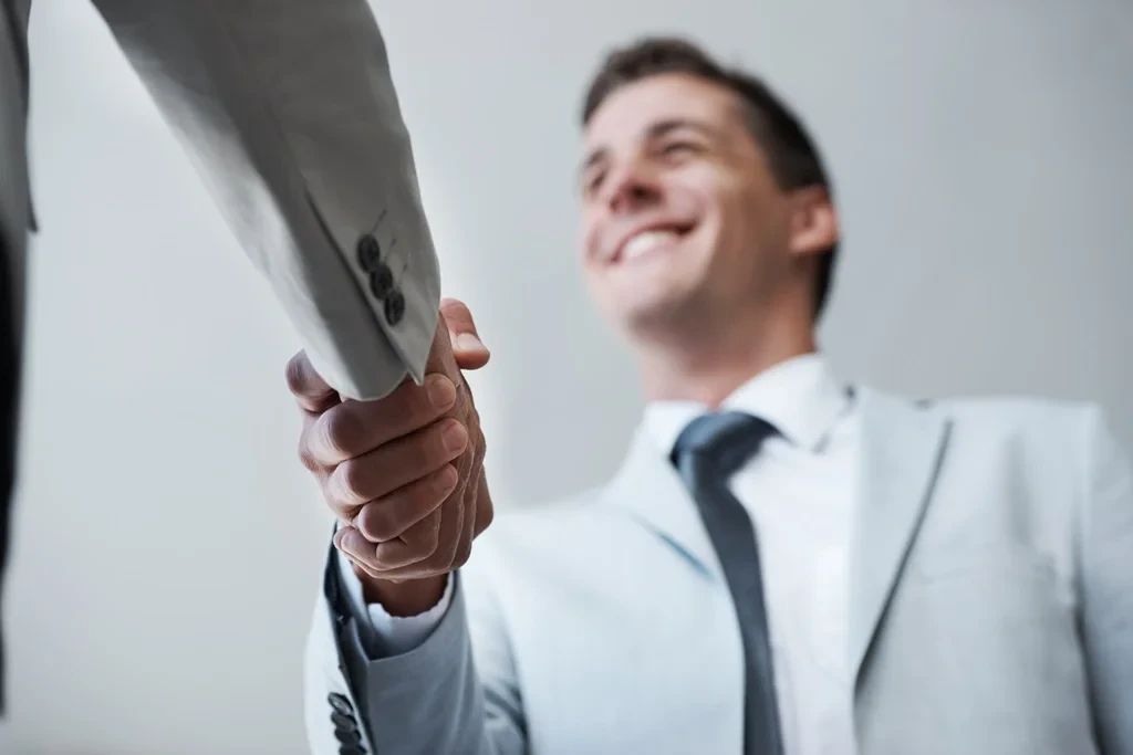 Applicant Shaking The Hands Of The Recruiter After A Successful Interview