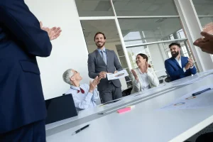 Employee Receiving A Surprise Promotion During A Meeting