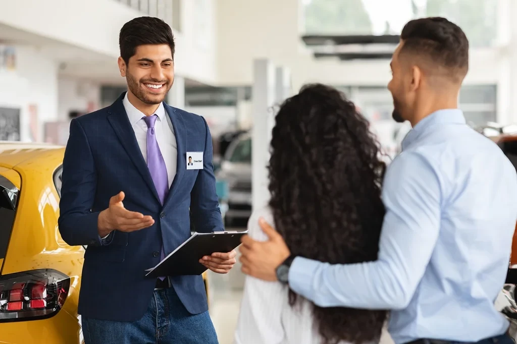 Friendly Sales Assistant Talking With Customers At Work