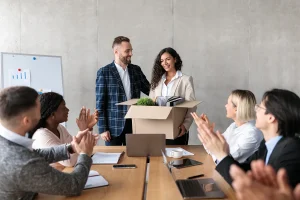 businessman introducing new coworker to employees during meeting in office