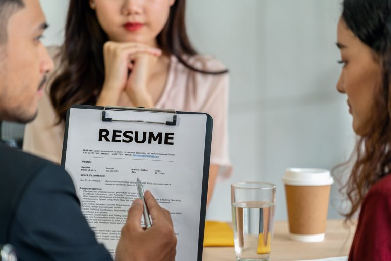 A job interviewer reading the Personal Characteristics in Resume