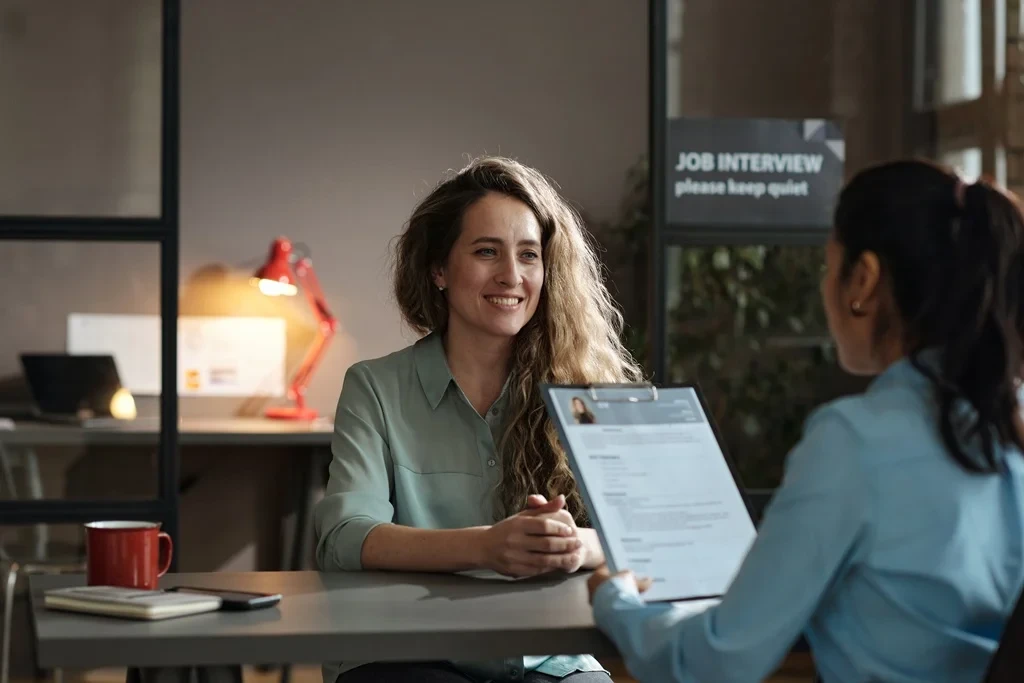 Confident Job Applicant Waiting For The Hiring Manager To Read Her Resume