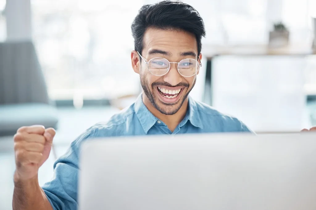 Joyful Job Seeker Smiling While Reading An Interview Invitation Email