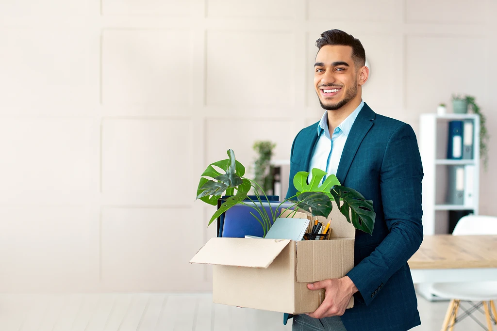 Portrait Of A Confident Businessman With Belongings Relocating For A Job And Moving To A New Office