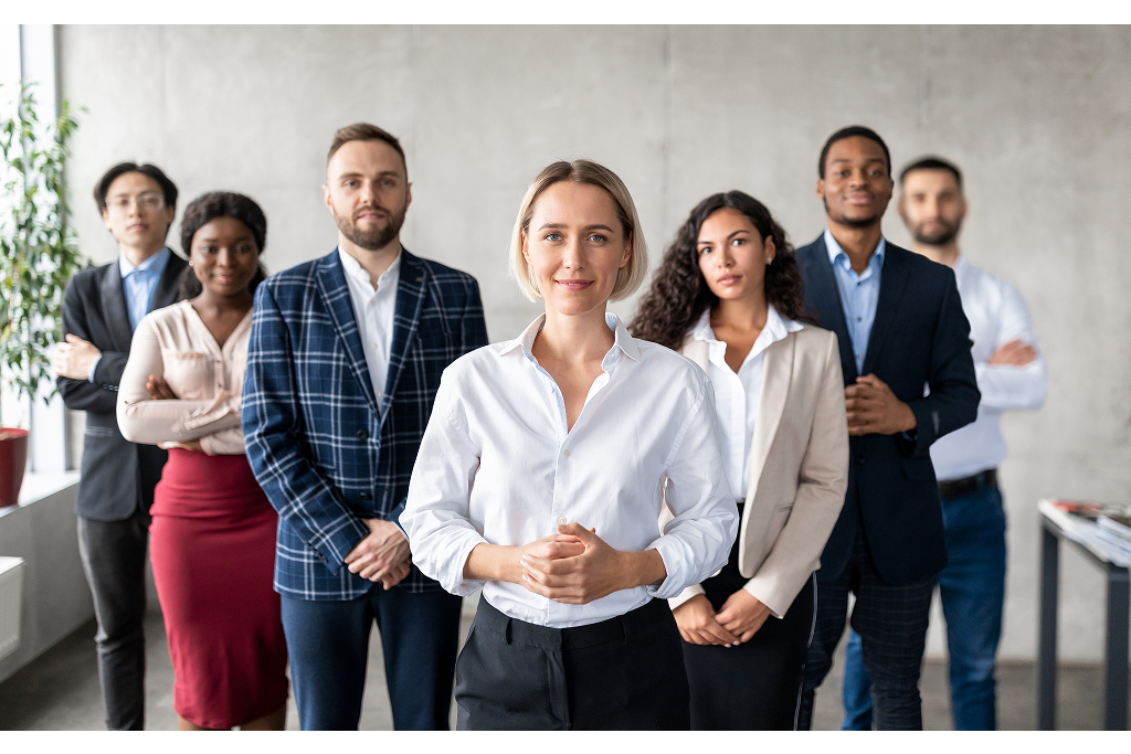 Successful Businesswoman Standing In Front Of Business Team In Office