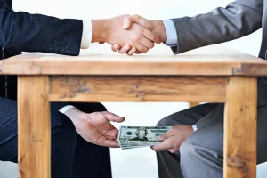 two men shaking hands after they negotiate salary