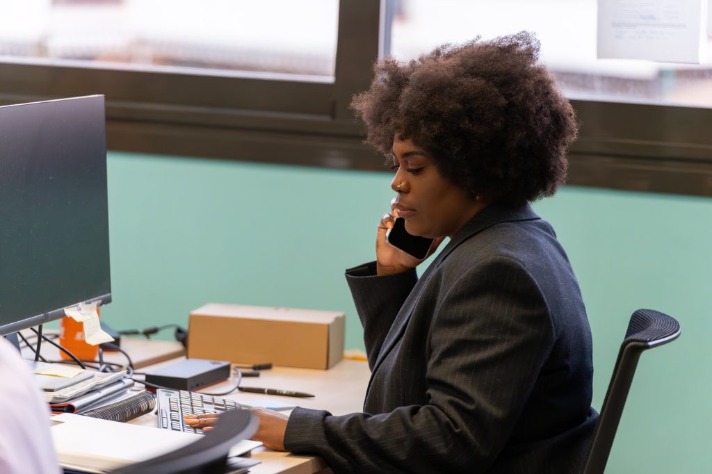 Woman Multitasking With Phone And Computer.