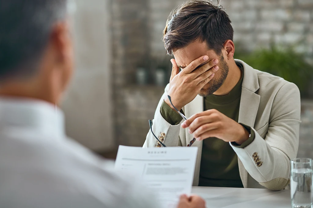 Worried Male Candidate Having A Job Interview In The Office