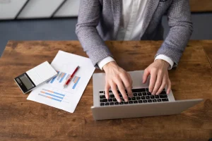 businessman working on laptop with documents