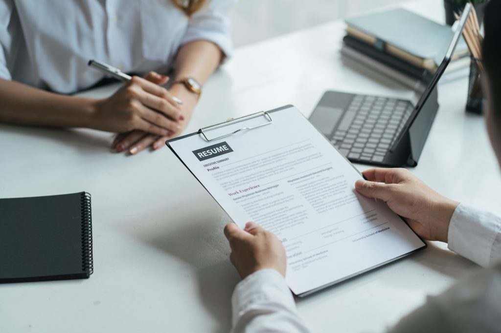 Close Up View Of Job Interview In Office, Focus On Resume Writing Tips, Employer Reviewing Good Cv