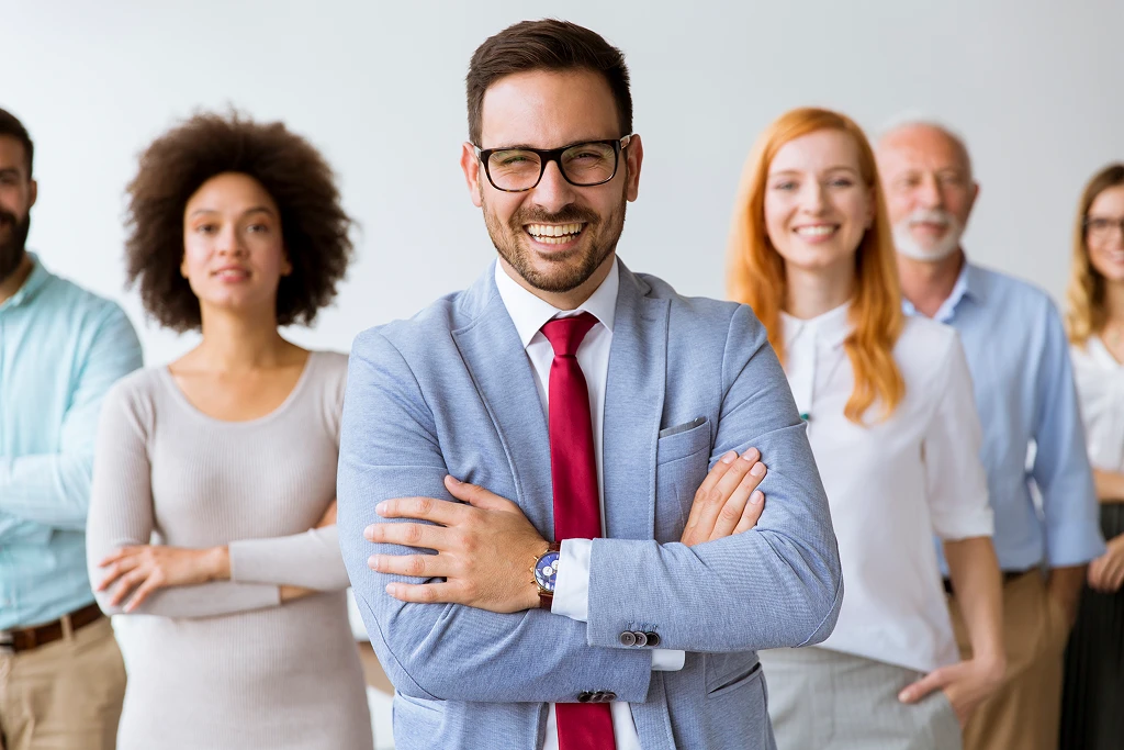 Happy And Positive Business People Standing In The Office