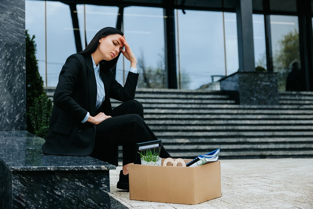 Person Sits Alone Outside Appearing Withdrawn And Uninterested Showing Signs That Indicate Quiet Quitting