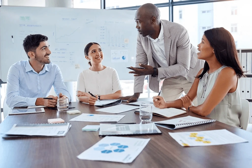 Team Of Employees Attentively Listening To Their Team Leader