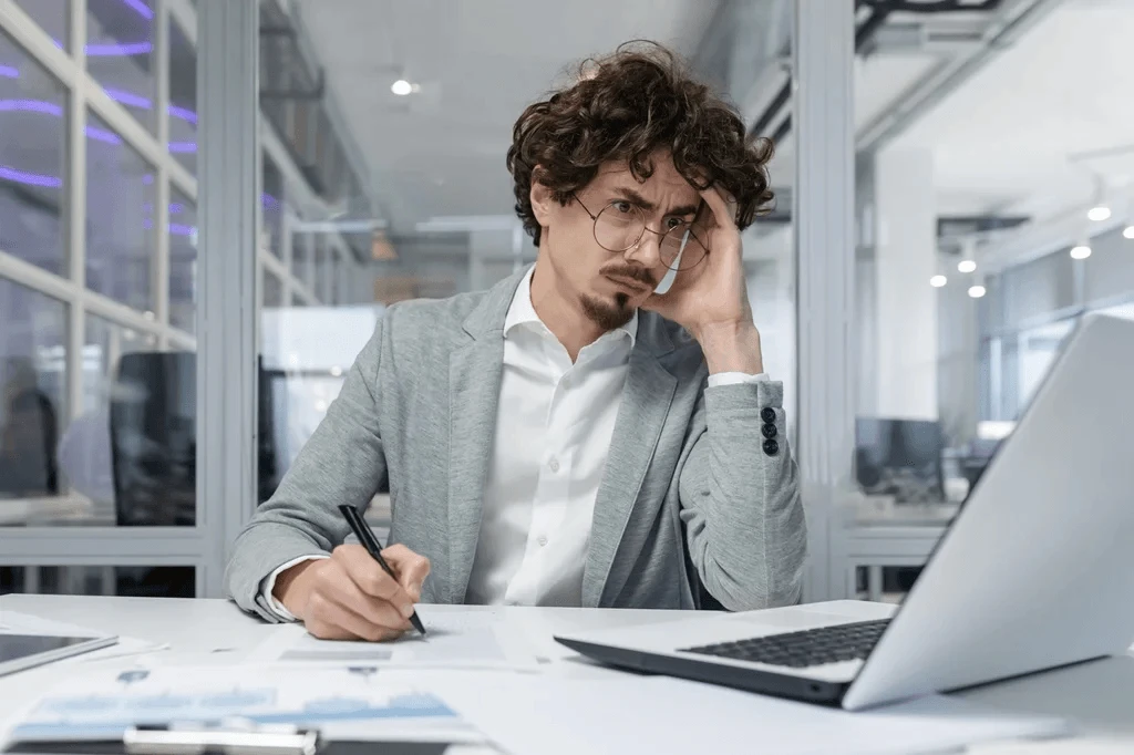 Unhappy Employee Showing Signs Of Frustration Or Dissatisfaction At Work